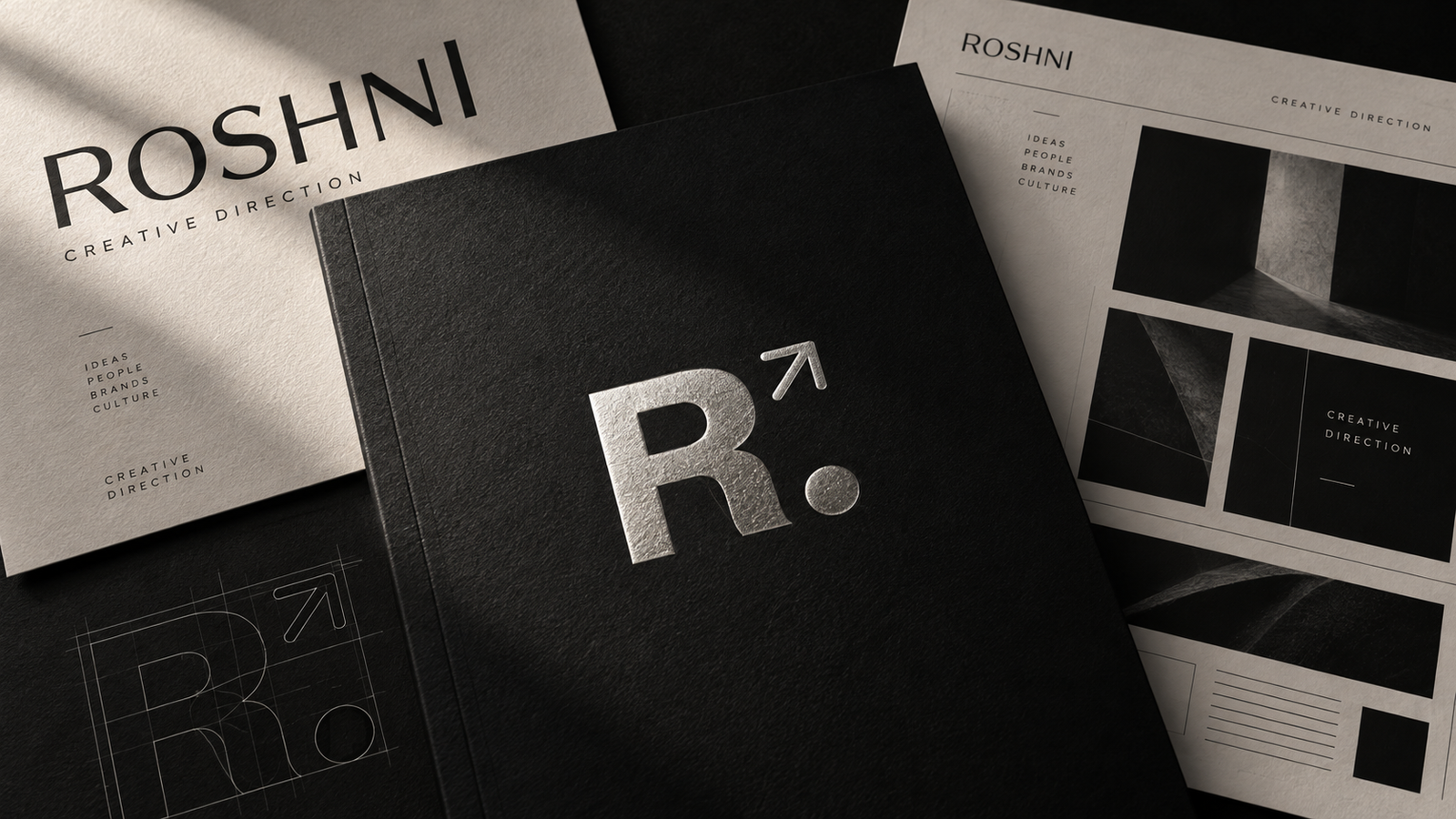 Black-and-white editorial design composition with refined typography, printed layouts and the embossed Roshni R mark